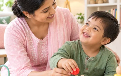Indian caregiver helping a child with special needs during sensory play